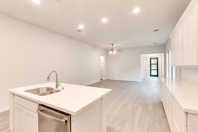 Kitchen with a sink, dishwasher, a ceiling fan, white cabinets, and recessed lighting | Image 13