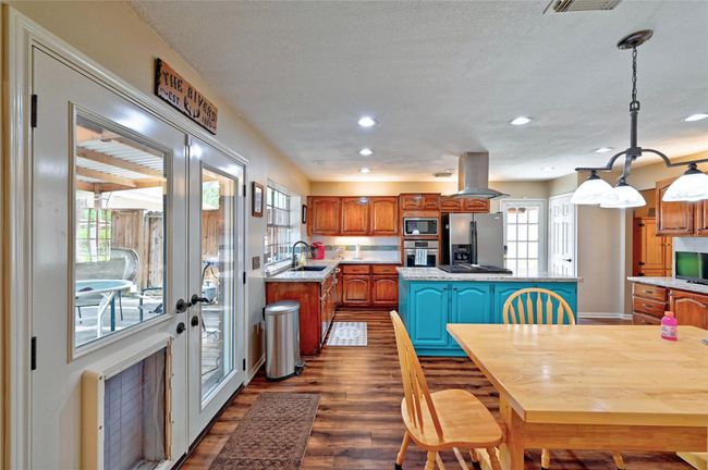 Experience a spacious and inviting atmosphere with the seamless blend of the kitchen and breakfast area, perfect for family gatherings and entertaining. | Image 11