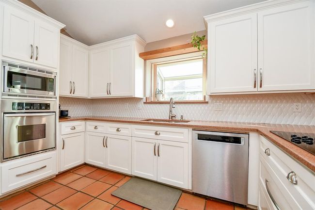 Cabinetry, counters and appliances are placed everywhere your tasks take you! | Image 21