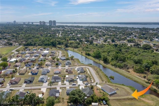 Aerial overview of property's location featuring a large body of water and nearby suburban area | Image 20
