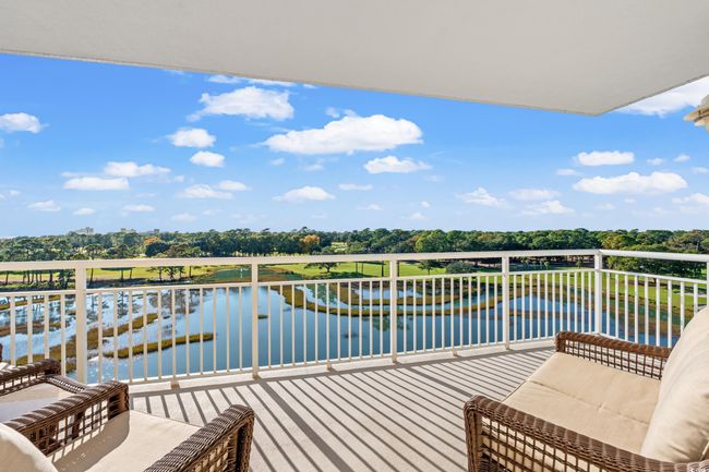 Balcony featuring view of scattered trees and a water view | Image 21