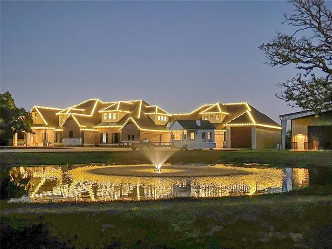 The home is adorned with custom-designed LED Christmas lights along the entire roofline, creating a stunning festive display. Integrated into the home's lighting system, these lights automatically turn on at dusk and off at dawn, offering hassle-free holiday cheer without any need for manual adjustments. It’s the perfect touch to make your home glow during the holiday season! | Image 34