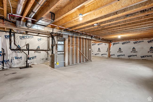 Unfinished basement featuring heating unit | Image 45
