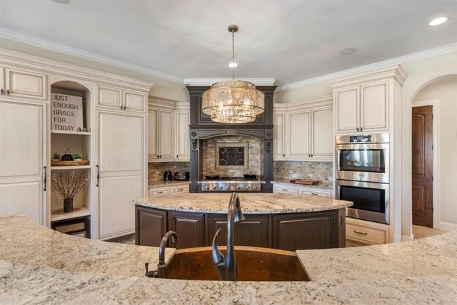 Experience culinary excellence in this chef's dream kitchen featuring elegant dual islands, top-of-the-line appliances, and sophisticated finishes. | Image 12
