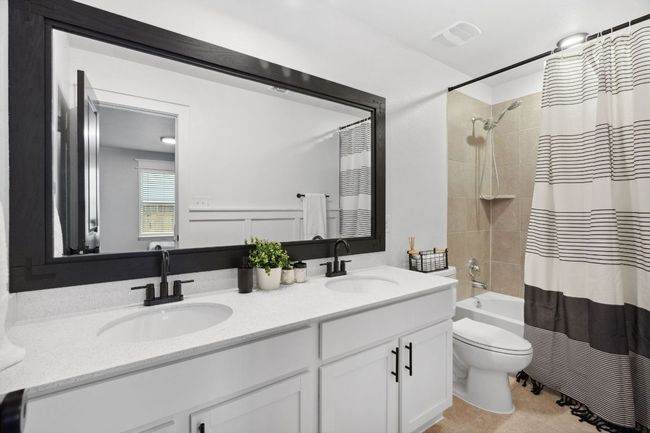 The second full bath is well-appointed near the bonus room and two secondary bedrooms. | Image 27