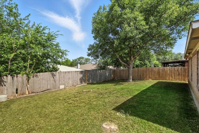 View of fenced backyard | Image 17