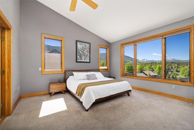 Bedroom featuring a mountain view, vaulted ceiling, carpet flooring, and a ceiling fan | Image 8