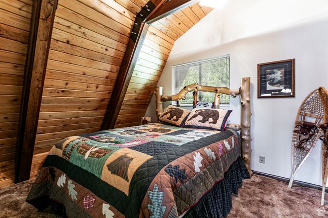 Carpeted bedroom with lofted ceiling and baseboards | Image 15