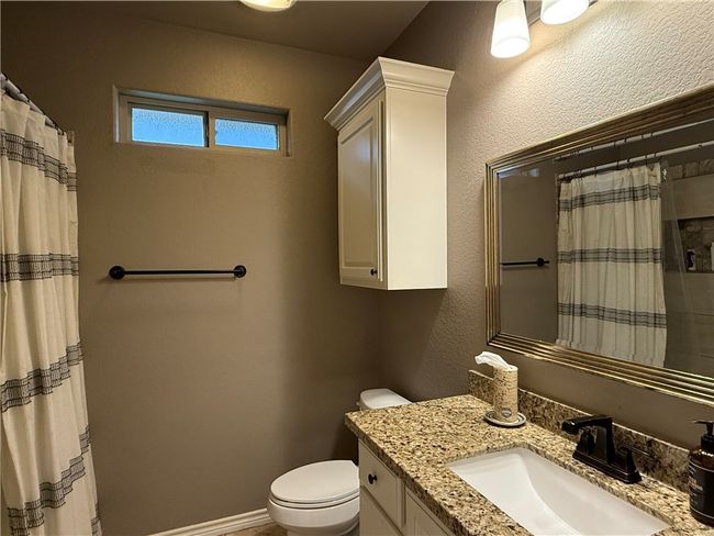 Full bath featuring vanity and curtained shower | Image 18