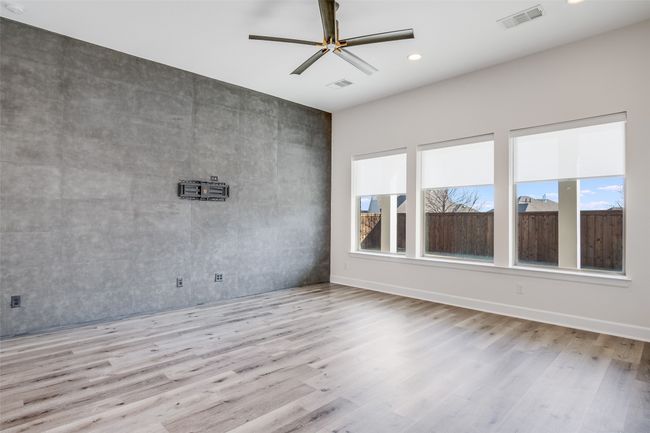 Empty room featuring healthy amount of natural light, wood finished floors, a ceiling fan, and recessed lighting | Image 15