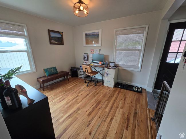 Home office featuring light wood-type flooring and baseboards | Image 21