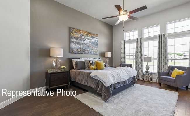 Bedroom featuring wood finished floors, multiple windows, and ceiling fan | Image 6