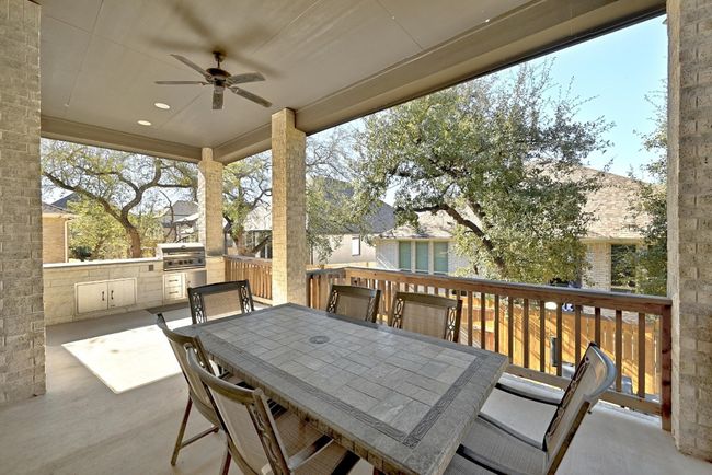 The covered patio provides a perfect spot for entertaining, with easy access to both the living area and backyard. | Image 24