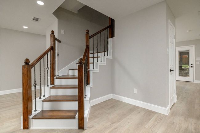 Stairway with wood finished floors and recessed lighting | Image 8