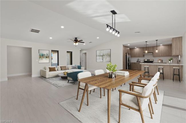 Dining space with ceiling fan, light hardwood / wood-style floors, and lofted ceiling | Image 7