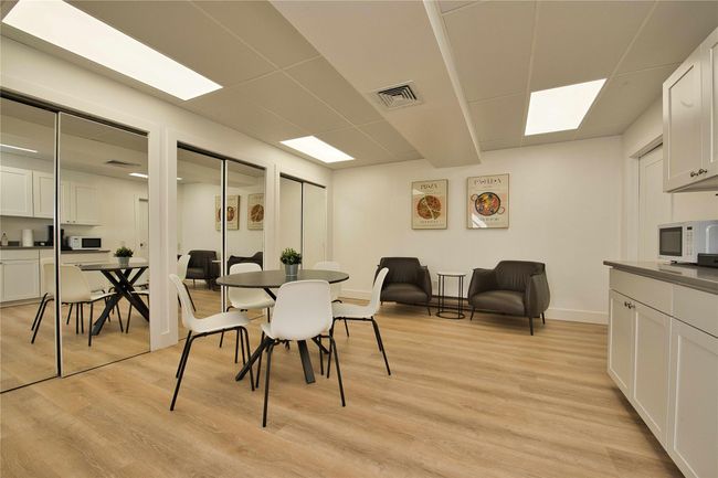 Dining area with light wood-style flooring, baseboards, and a paneled ceiling | Image 6