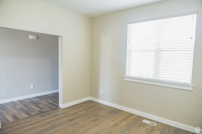 Spare room featuring wood finished floors and healthy amount of natural light | Image 25