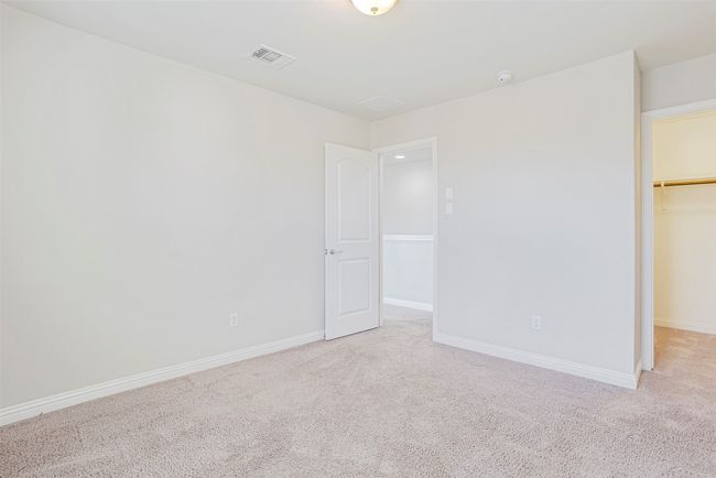 Unfurnished bedroom with light colored carpet and a walk in closet | Image 27