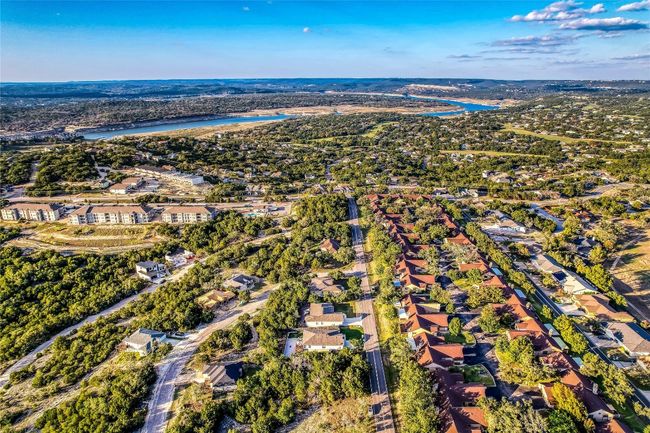 Aerial overview of property's location with a large body of water and nearby suburban area | Image 34