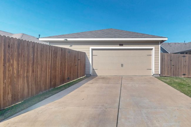 View of side of property with fence, a garage, and concrete driveway | Image 17