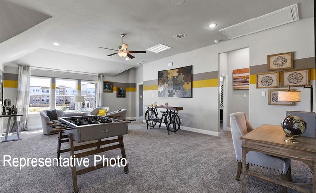 Rec room featuring attic access, carpet, a ceiling fan, recessed lighting, and lofted ceiling | Image 9
