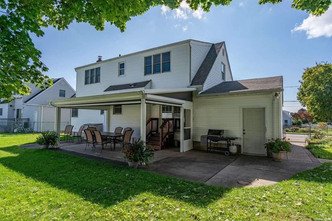 Back yard looking at house with Life Room screens DOWN | Image 26