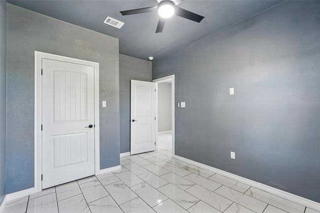 Empty room featuring tile finish floor, baseboards, and ceiling fan | Image 20