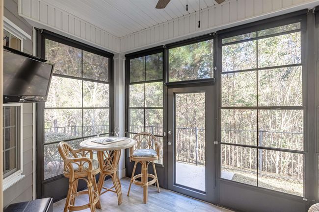 Sunroom / solarium featuring ceiling fan, a healthy amount of sunlight, and wood ceiling | Image 31