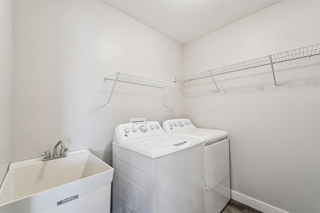 Main floor laundry with a laundry sink. | Image 21