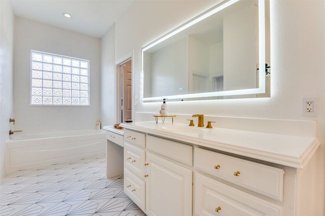 Bathroom featuring a garden tub, recessed lighting, and vanity | Image 10