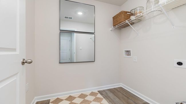 Laundry area featuring washer hookup, hookup for an electric dryer, laundry area, visible vents, and baseboards | Image 24