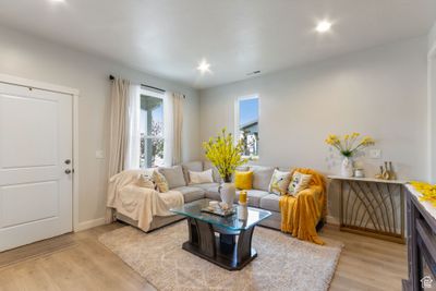 Living room featuring wood-type flooring and a large fireplace | Image 3