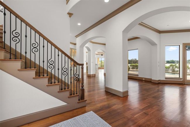 The walls of windows bring the outside vistas inside further enhancing the tranquil ambience in the impressive open concept living space of the home. | Image 9