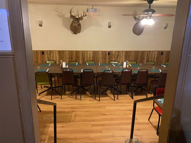 Dining room with a wainscoted wall, wood finished floors, a ceiling fan, and wood walls | Image 5