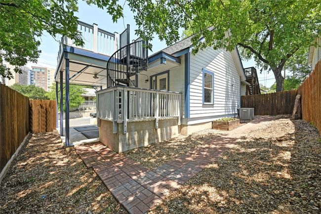 A small partially fenced low maintenance yard. | Image 21