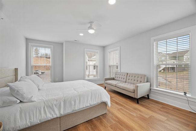 Bedroom 3 with LVP flooring, recessed lighting, ceiling fan and walk-in closet. Abundance of natural light, windows with custom blinds | Image 28