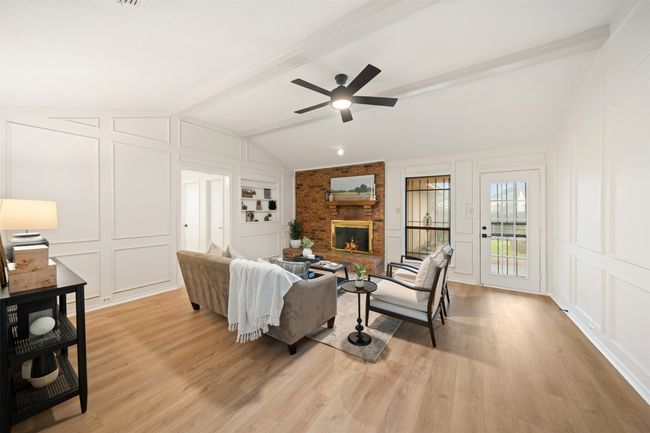 Living area with vaulted ceilings, a fireplace, and LVP floors | Image 10