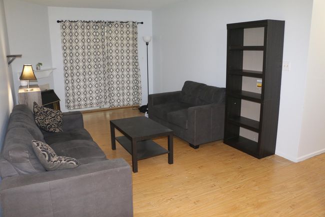Living area with light wood-style flooring and baseboards | Image 11