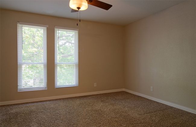 Unfurnished room featuring baseboards, a ceiling fan, and carpet flooring | Image 18