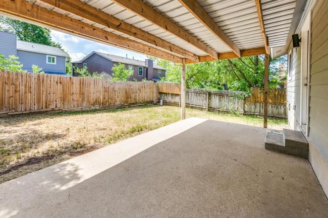 View of patio with a fenced backyard | Image 24