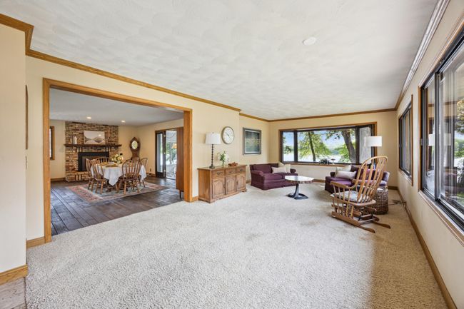 Another photof of the great room with windows with great views overlooking the lake. Into what is set up as the dining room. Could be the family room with dining in the great room. | Image 5