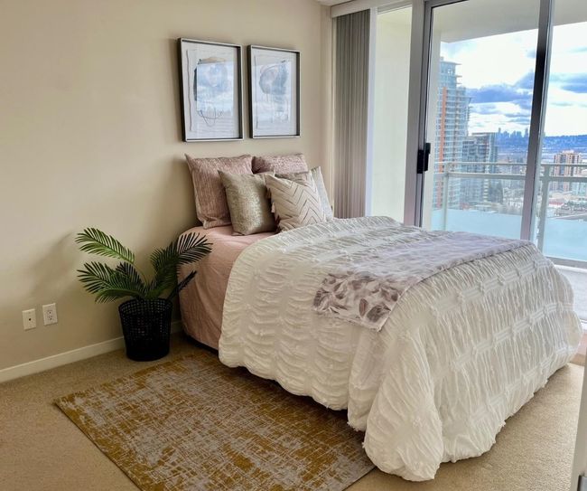 Bedroom featuring a city view, baseboards, and carpet | Image 13