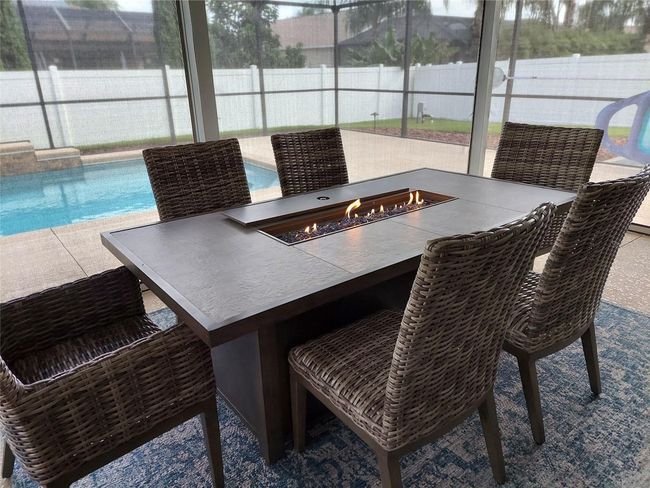 Lanai dining set has firepit table and rattan seating. Dining set is optional. | Image 25