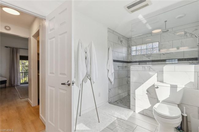 Full bath featuring visible vents, walk in shower, a healthy amount of sunlight, and toilet | Image 23