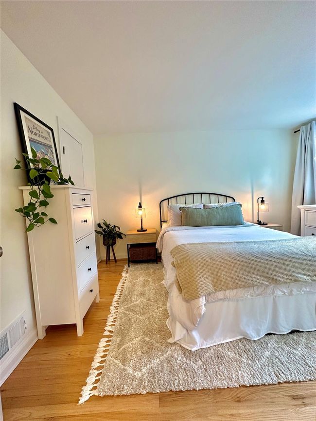 Bedroom with light wood-type flooring and baseboards | Image 16