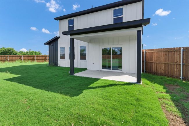 Rear view of property with board and batten siding and a patio area | Image 40