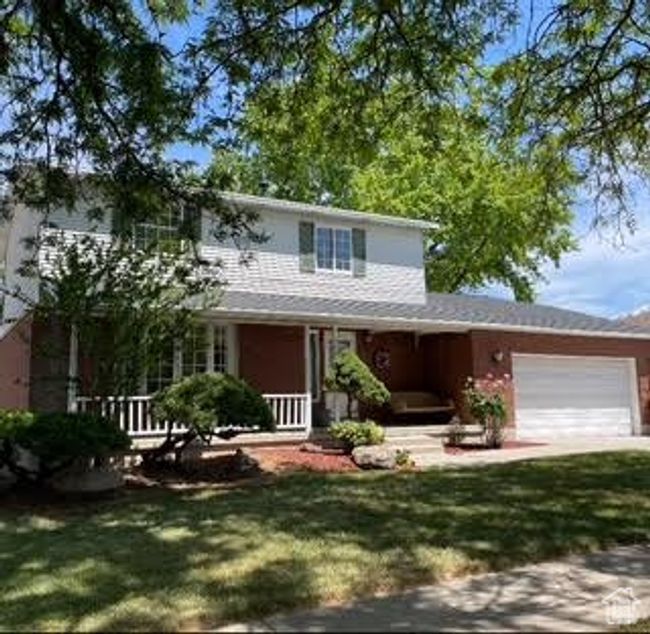 View of front of home with a porch, a garage, and a front yard | Image 12