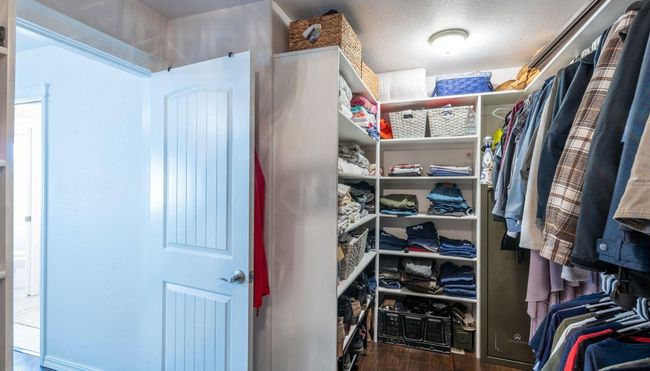 Walk in closet featuring wood finished floors | Image 20