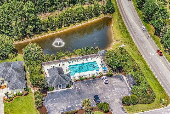 Bird's eye view of a nearby body of water and a pool area | Image 36