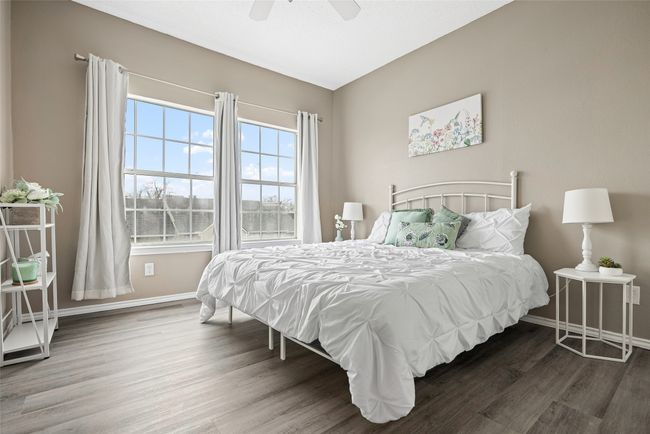 Spacious primary bedroom currently features a king bed and still has lots of space to move around. | Image 14